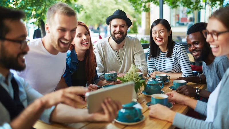 a group of people sitting around a wooden table